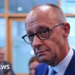German Chancellor Merz calls state election a ‘disaster’ for his party but vows to stay on